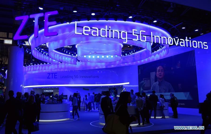 People are seen at the booth of Chinese telecom company ZTE at the 2019 Mobile World Congress (MWC) in Barcelona, Spain, Feb. 25, 2019. The four-day 2019 MWC opened on Monday in Barcelona. (Xinhua/Guo Qiuda)