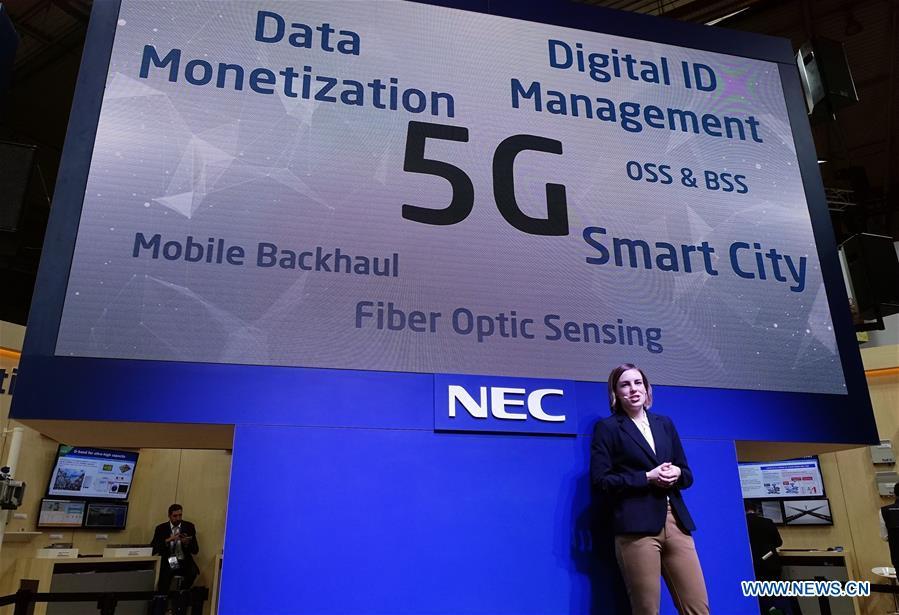 Japan\'s NEC holds a presentation about its 5G projects at Mobile World Congress (MWC 2019) in Barcelona, Spain, Feb. 26, 2019. The four-day MWC 2019 opened its door on Monday, which presents the newest 5G products of the high-tech giants from all around the world. (Xinhua/Guo Qiuda)