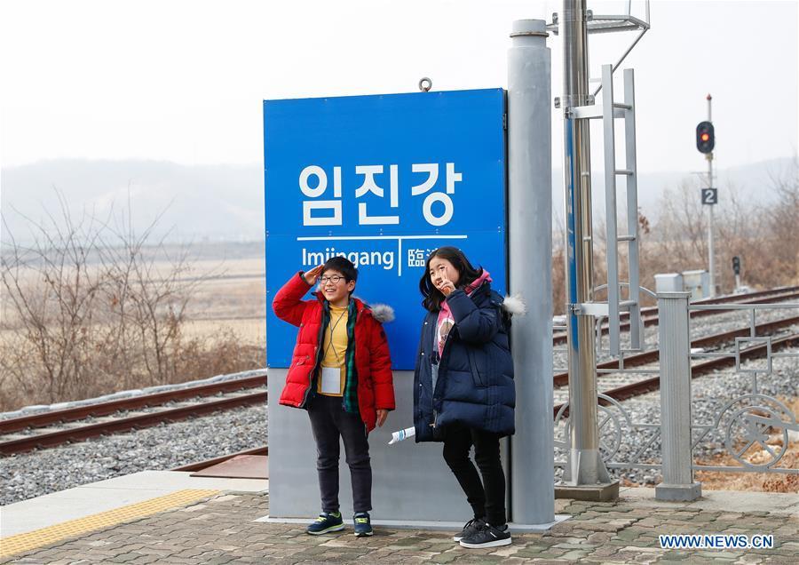 Two children pose for photos at the Imjingang Station in Paju, South Korea, Feb. 20, 2019. Created in 1953 when the three-year Korean War ended with armistice, the Demilitarized Zone (DMZ) has long been a symbol of both confrontation and peace as tensions or rapprochement across the inter-Korean border can be felt firsthand in the 250-km-long strip of no-man\'s land. The DMZ Train departed Seoul Station for Dorasan Station, the northernmost station of the ROK just about 50 km north of Seoul and only 700 meters south of the southern boundary of the 4-km-wide DMZ. (Xinhua/Wang Jingqiang)