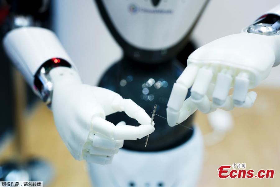 A robot sews at the Mobile World Congress in Barcelona, Spain, Feb. 26, 2019. The annual Mobile World Congress (MWC) runs from 25-28 February in Barcelona, where companies from all over the world gather to share new products. (Photo/Agencies)