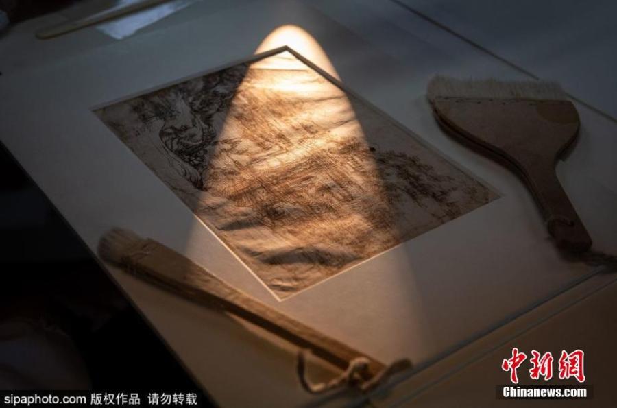 The landscape drawing for Santa Maria della Neve, attributed to Leonardo da Vinci on Aug. 5, 1473, is under scientific analyses in Florence, Italy. Aided by sophisticated, non-invasive instruments, such as infrared light, the experts on Thursday scrutinized the front of the drawing. The first-ever scientific study of a Leonardo drawing done in his youth shows the artist added details to earlier sketch. (Photo/Agencies)