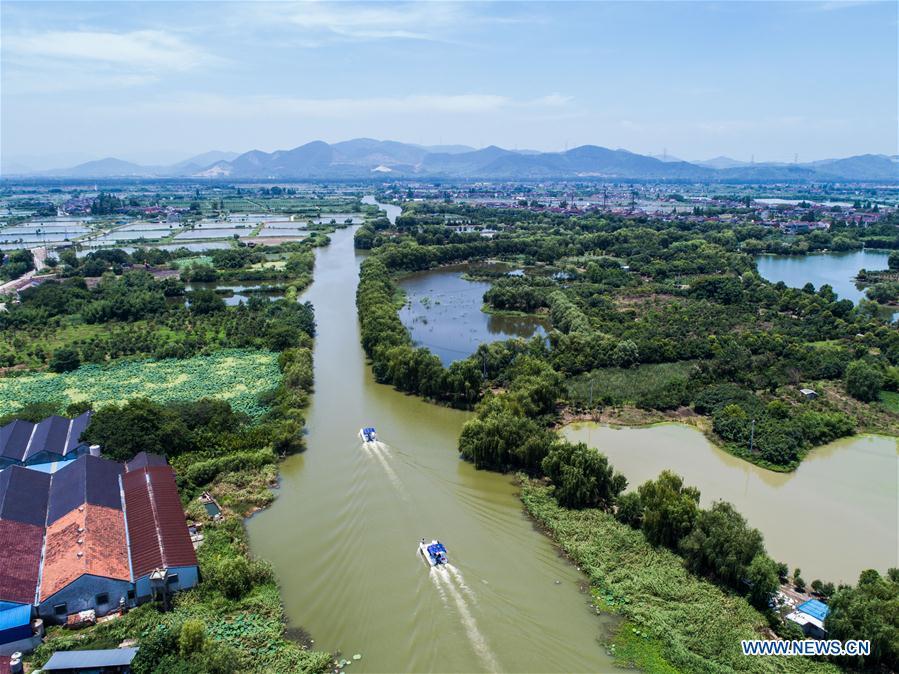 Aerial photo taken on July 10, 2018 shows river chief and other staff members patrolling on a river at Baojian Village of Huzhou City, east China\'s Zhejiang Province. As \