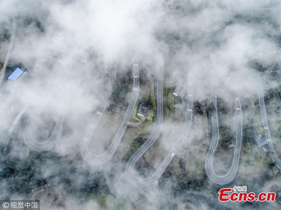 A winding mountain road, which has become a tourist attraction for its ten bends, is shrouded in mist in Taiyanghe Township, Enshi Tujia and Miao Autonomous Prefecture, Hubei Province, March 3, 2019. (Photo/VCG)