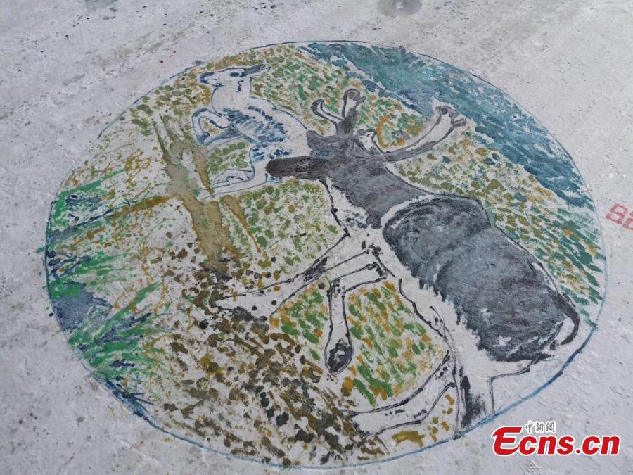 Paintings adorn the ground during an ice and snow festival in the Aoluguya Ewenki ethnic township in the Inner Mongolia Autonomous Region, March 5, 2019. The paintings depict the customs and natural landscape of the township, home to China\'s only reindeer-herding tribe. (Photo: China News Service/Zheng Wei and Deng Hongpeng)