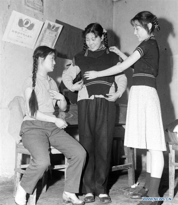 Women with braids try on sweaters at a knitting factory in Urumqi, northwest China\'s Xinjiang Uygur Autonomous Region, April 20, 1961. Along with China\'s reform and opening-up starting from 1978, Chinese women have refreshed their images year after year, which can be simply seen from their hairstyles. Women\'s hairstyles, just like a mirror, reflect fashion changes and most importantly, Chinese women\'s increasingly diversified definition of beauty. (Xinhua)