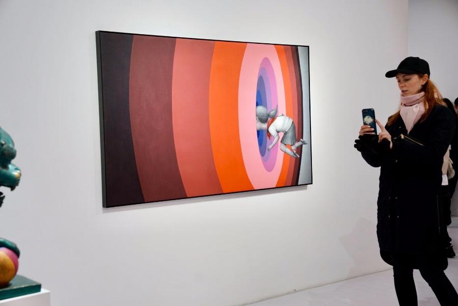 Visitors take photos of the artworks at the exhibition.(Photo/chinadaily.com.cn)

Born in Paris in 1972, Malland rose to fame in Shanghai with his paintings of children on the walls in different parts of the city.

He started painting on walls in the mid-1990s and has since 2003 been touring the world to interact with street artists from different cultures.