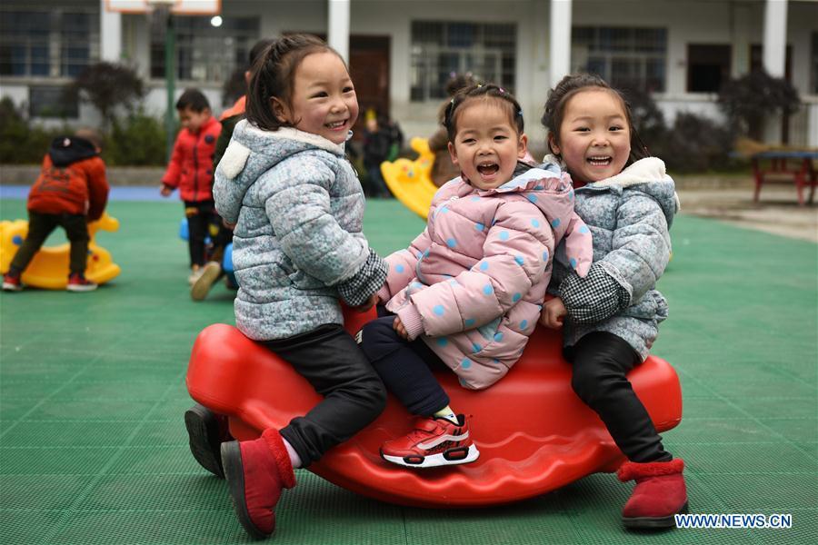 Huang Xingqi (1st R) and her twin sister Huang Xingyi (1st L) take part in outdoor activities at a kindergarten in Yuping Dong Autonomous County of Tongren, southwest China\'s Guizhou Province, Feb. 28, 2019. China\'s efforts and success in poverty reduction can help other developing nations, said experts observing the country\'s ongoing Two Sessions. The Two Sessions refer to the annual gatherings of the National People\'s Congress (NPC) and the National Committee of the Chinese People\'s Political Consultative Conference, China\'s top legislature and political advisory body respectively. China has emerged as a global role model with efforts in structural transformation and industrial upgrading, lifting hundreds of millions of people out of poverty, said retired Lieutenant Colonel Muhammad Faruk Khan, a presidium member of Bangladesh\'s ruling Awami League. (Xinhua/Yang Wenbin)