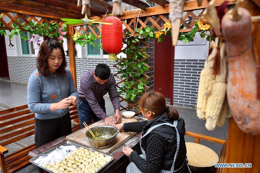 Duan Suhua (L), who runs a hostel, makes dumplings for tourists at her farmhouse in Niangziguan Village of Niangziguan Town in Pingding County, north China\'s Shanxi Province, on Feb. 26, 2019. China\'s efforts and success in poverty reduction can help other developing nations, said experts observing the country\'s ongoing Two Sessions. The Two Sessions refer to the annual gatherings of the National People\'s Congress (NPC) and the National Committee of the Chinese People\'s Political Consultative Conference, China\'s top legislature and political advisory body respectively. China has emerged as a global role model with efforts in structural transformation and industrial upgrading, lifting hundreds of millions of people out of poverty, said retired Lieutenant Colonel Muhammad Faruk Khan, a presidium member of Bangladesh\'s ruling Awami League. (Xinhua/Cao Yang)

China\'s efforts and success in poverty reduction can help other developing nations, said experts observing the country\'s ongoing Two Sessions.

The Two Sessions refer to the annual gatherings of the National People\'s Congress (NPC) and the National Committee of the Chinese People\'s Political Consultative Conference, China\'s top legislature and political advisory body respectively.

China has emerged as a global role model with efforts in structural transformation and industrial upgrading, lifting hundreds of millions of people out of poverty, said retired Lieutenant Colonel Muhammad Faruk Khan, a presidium member of Bangladesh\'s ruling Awami League.

In the government work report delivered at the opening of the annual NPC session on Tuesday, Premier Li Keqiang pledged that China will reduce its rural poor population by over 10 million this year.

Official figures show that over the past 40 years, China has lifted more than 700 million rural residents out of poverty, and the poverty rate, proportion of people living below the Chinese poverty line, had fallen among rural population from 97.5 percent in 1978 to 3.1 percent at the end of 2017.

China\'s reform and opening-up drive has transformed its economy and helped maintain its financial stability, said Khan, adding that China\'s experience \
