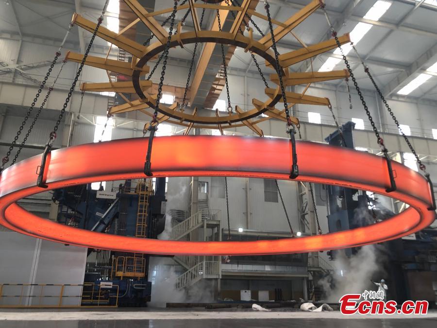 A non-welded stainless steel ring, the world’s largest of its kind, is unveiled by the Institute of Metal Research at the Chinese Academy of Sciences, March 12, 2019. The ring, made by the institute using its own technologies, has a diameter of 15.6 meters and weighs 150 tons, setting a world record. It will be used in China\'s fourth-generation nuclear power reactor. (Photo: China News Service/Liu Yan)
