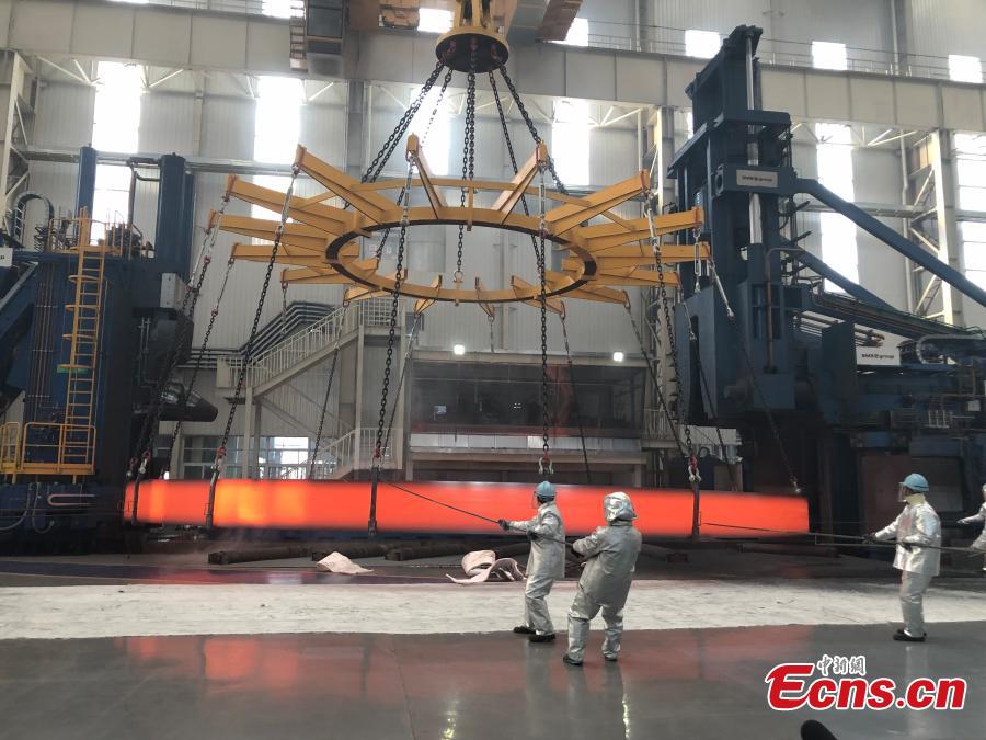A non-welded stainless steel ring, the world’s largest of its kind, is unveiled by the Institute of Metal Research at the Chinese Academy of Sciences, March 12, 2019. The ring, made by the institute using its own technologies, has a diameter of 15.6 meters and weighs 150 tons, setting a world record. It will be used in China\'s fourth-generation nuclear power reactor. (Photo: China News Service/Liu Yan)