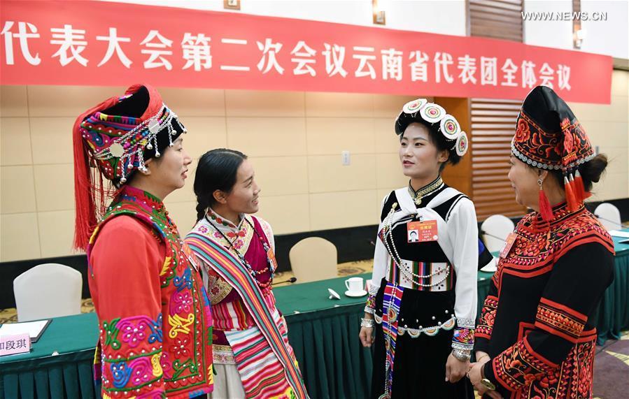 Fan Yongzhen (2nd R), a deputy to the 13th National People\'s Congress (NPC), talks with her fellow deputies after a plenary meeting of Yunnan delegation in Beijing, capital of China, March 7, 2019. (Xinhua/Yang Zongyou)

Sitting among nearly 3,000 national lawmakers at the Great Hall of the People at the heart of Beijing, Fan Yongzhen feels a great sense of responsibility to her people.

A deputy curator of a local cultural museum in southwest China\'s Yunnan Province, Fan wants more funding for preserving ethnic minority cultures, as well as better technologies in public museums in less developed areas.

The annual \