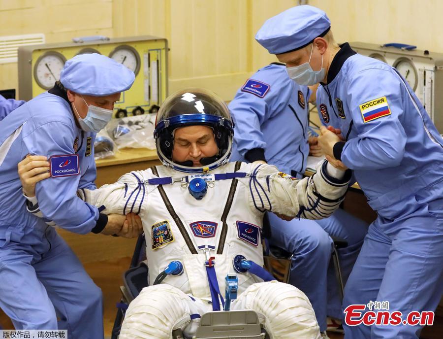 The International Space Station (ISS) crew member Aleksey Ovchinin of Russia is assisted during his space suit check at the Baikonur Cosmodrome, Kazakhstan March 14, 2019. (Photo/Agencies)
