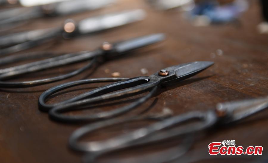 Craftsman Ding Jican makes Zhang Xiaoquan scissors using traditional methods in Hangzhou City, East China\'s Zhejiang Province, March 18, 2019. Zhang Xiaoquan scissors are a famous brand with a long history in China, and Ding has been committed to making the household utensil for 40 years. Ding himself is a master of the Zhang Xiaoquan scissor-making techniques, which have been perfected over the centuries and are recognized in China as a state intangible cultural heritage. (Photo: China News Service/Wang Gang)