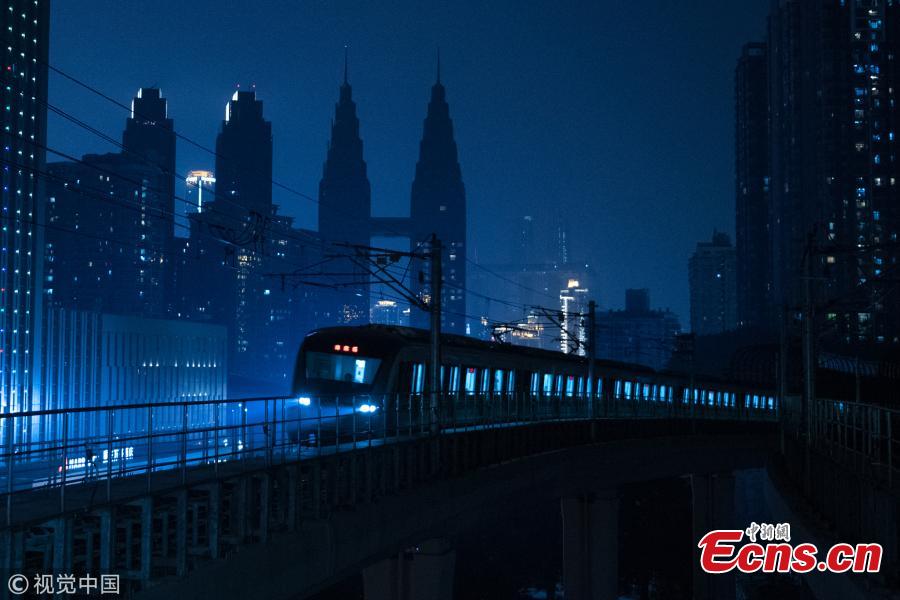 Photo shows a train leaving a subway station in Southwest China\'s Chongqing, on March 11, 2019. Haitangxi Station, a light rail station on a loop line in Chongqing, became popular online for its vibrant appearance at night.  (Photo/VCG)