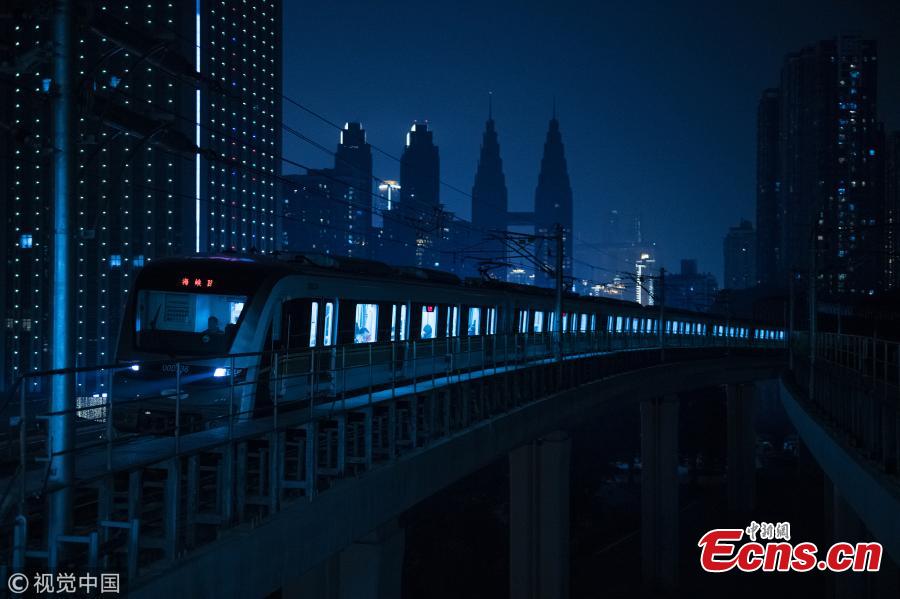 Photo shows a train leaving a subway station in Southwest China\'s Chongqing, on March 11, 2019. Haitangxi Station, a light rail station on a loop line in Chongqing, became popular online for its vibrant appearance at night.  (Photo/VCG)