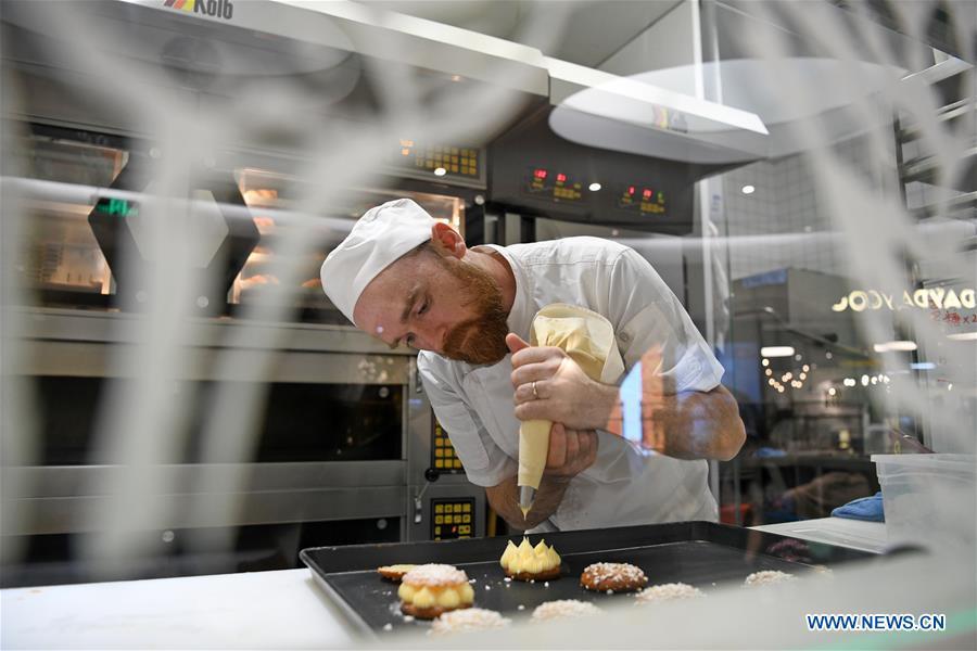 French baker Christophe makes desserts at his bakery store in Guangzhou, south China\'s Guangdong Province, March 21, 2019. French baker Christophe and his wife Agnes started their first French bakery store called \