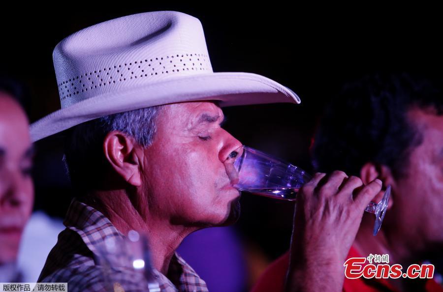 A man drinks tequila as 1,486 people gather to hold a tequila tasting at the Plaza Liberacion in Guadalajara, Jalisco, Mexico, on March 24, 2019 in an attempt to set a new Guinness World Record for the \