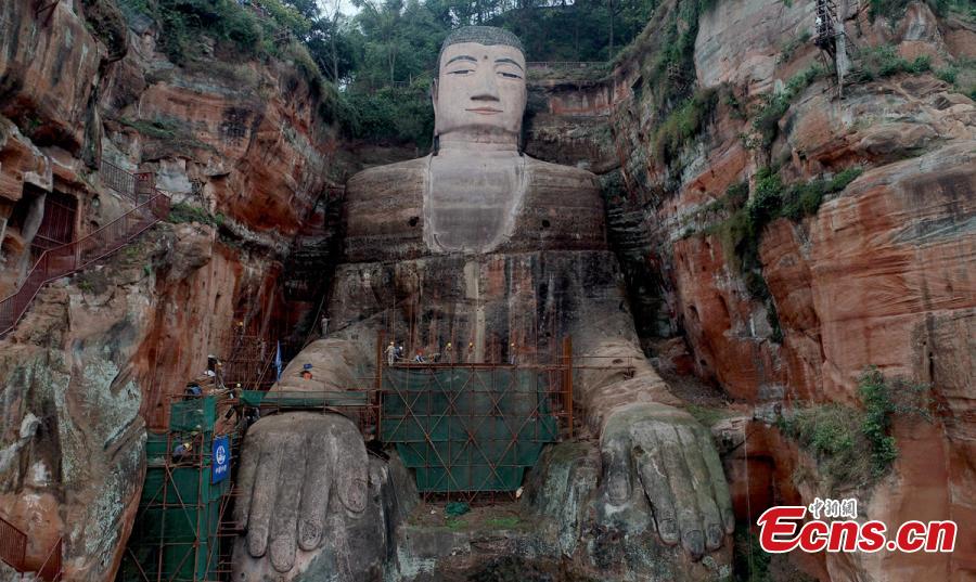 Work continues to restore the Giant Buddha of Leshan in Sichuan Province, March 25, 2019. Standing 71 meters high, the statue was carved out of a hillside in the 8th century and looks down on the confluence of three rivers. It will reopen to tourists on April 1 after undergoing repairs for the past six months. Mount Emei Scenic Area, including the Leshan Giant Buddha, was inscribed as a UNESCO world heritage site in 1996. (Photo: China News Service/Liu Zhongjun)