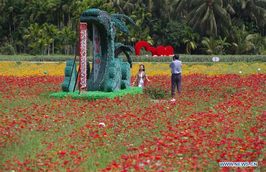 A visitor poses for photos at a garden in Nanqiang Village, Boao Town, Qionghai City of south China\'s Hainan Province, March 25, 2019. Qionghai City has quickened its steps towards the construction of \
