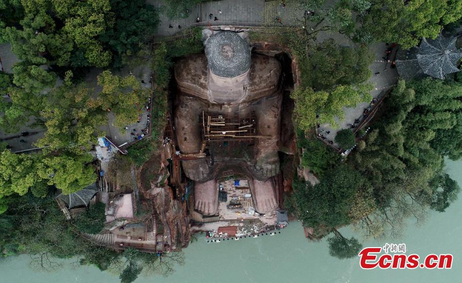 Work continues to restore the Giant Buddha of Leshan in Sichuan Province, March 25, 2019. Standing 71 meters high, the statue was carved out of a hillside in the 8th century and looks down on the confluence of three rivers. It will reopen to tourists on April 1 after undergoing repairs for the past six months. Mount Emei Scenic Area, including the Leshan Giant Buddha, was inscribed as a UNESCO world heritage site in 1996. (Photo: China News Service/Liu Zhongjun)