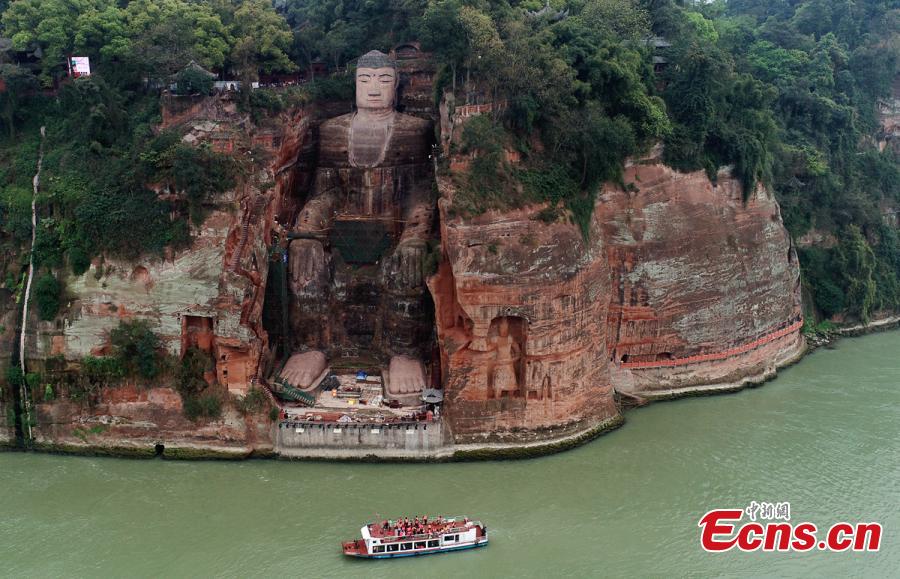 Work continues to restore the Giant Buddha of Leshan in Sichuan Province, March 25, 2019. Standing 71 meters high, the statue was carved out of a hillside in the 8th century and looks down on the confluence of three rivers. It will reopen to tourists on April 1 after undergoing repairs for the past six months. Mount Emei Scenic Area, including the Leshan Giant Buddha, was inscribed as a UNESCO world heritage site in 1996. (Photo: China News Service/Liu Zhongjun)