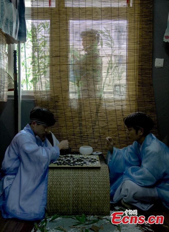 A newly-renovated dormitory room at the Wuhan Textile University Yangguang (Sunny) Campus in Wuhan City, Hubei Province, March 26, 2019. Four students have completely overhauled their dormitory room, decorating it with plastic bamboo trees, traditional window decorations and paintings reflecting Hui-style architecture. The four students are known to don traditional costumes and play Go, imitating the lifestyles of ancient Chinese scholars. (Photo: China News Service/Zhang Chang)
