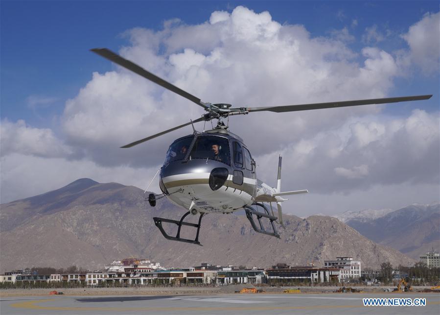 A tourism helicopter takes off in Lhasa, southwest China\'s Tibet Autonomous Region, March 20, 2019. Infrastructure has been improved in Tibet, as a comprehensive transportation network composed of highways, railways and air routes has been formed. (Xinhua/Jigme Dorje)