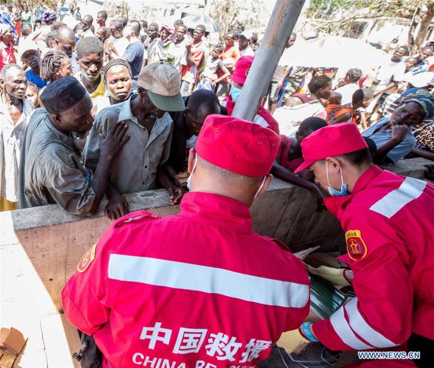 Members of Chinese rescue team distribute disaster relief goods in Lamago Village, 90 km from Beira, Mozambique, March 26, 2019. A Chinese rescue team went to Lamago Village to carry out disaster relief work on Tuesday. (Xinhua/Zhang Yu)