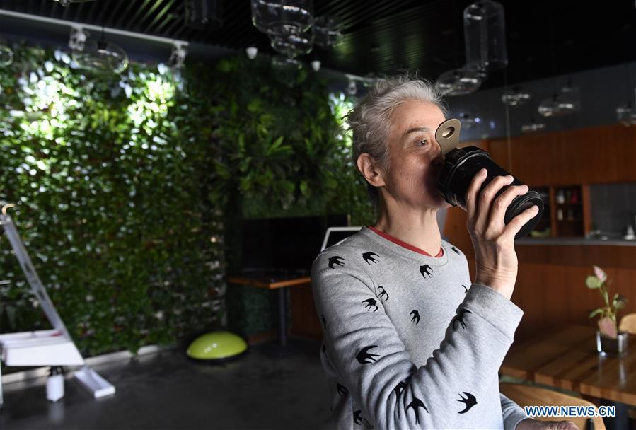 Bai Jinqin, a 74-year-old bodybuilding adept, relaxes after exercising at a gym in north China\'s Tianjin, March 13, 2019. Bai has kept exercising for 14 years. After finishing her housework, Bai likes to spend one hour every day at the gym to build her body. The hobby has rewarded her with good physique and energy. (Xinhua/Yue Yuewei)
