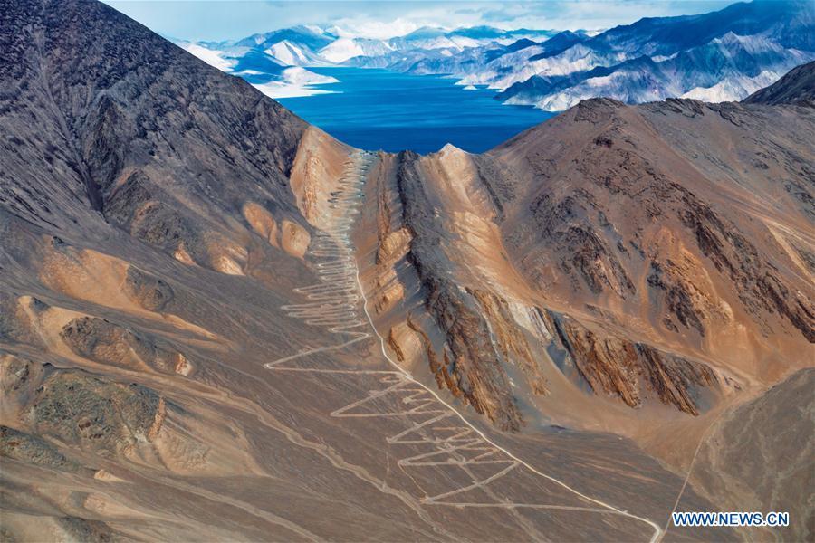 Photo taken on Nov. 9, 2015 shows a mountain road in Ali, southwest China\'s Tibet Autonomous Region. Infrastructure has been improved in Tibet, as a comprehensive transportation network composed of highways, railways and air routes has been formed. (Xinhua/Xiang Wenjun)