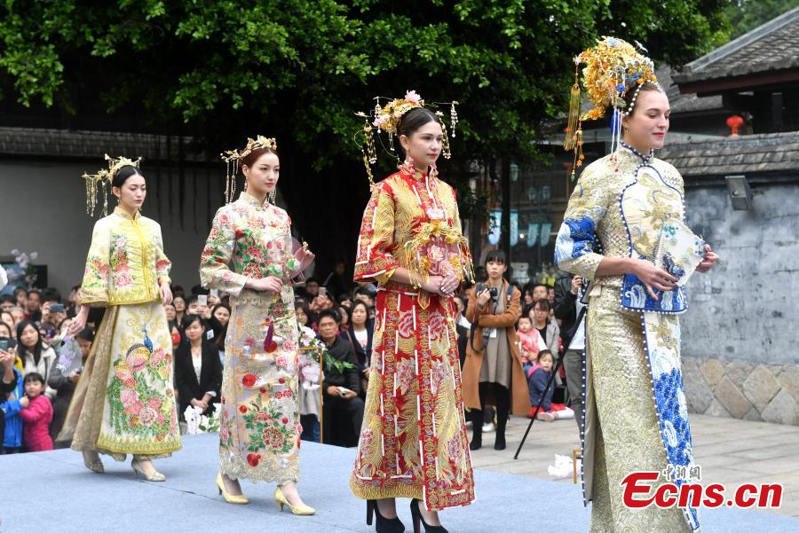 A wedding dress show held at the Three Lanes and Seven Alleys, a well-preserved architectural complex from the Ming and Qing dynasties in Fuzhou City, Fujian Province, March 31, 2019. Models from China and other countries presented wedding dresses that feature cultural traditions. (Photo: China News Service/Lyu Ming)