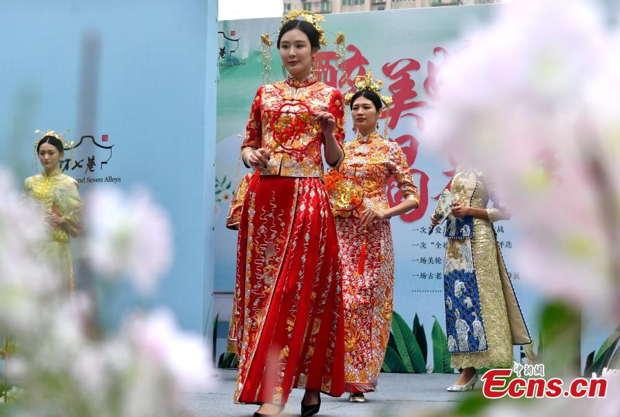 A wedding dress show held at the Three Lanes and Seven Alleys, a well-preserved architectural complex from the Ming and Qing dynasties in Fuzhou City, Fujian Province, March 31, 2019. Models from China and other countries presented wedding dresses that feature cultural traditions. (Photo: China News Service/Lyu Ming)