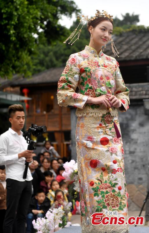 A wedding dress show held at the Three Lanes and Seven Alleys, a well-preserved architectural complex from the Ming and Qing dynasties in Fuzhou City, Fujian Province, March 31, 2019. Models from China and other countries presented wedding dresses that feature cultural traditions. (Photo: China News Service/Lyu Ming)