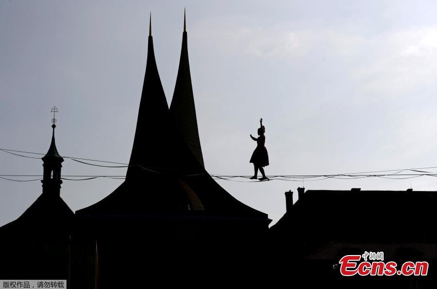 A tightrope?walker performs on ropes stretched over the Emmaus Monastery in Prague, Czech Republic, April 1, 2019. (Photo/Agencies)