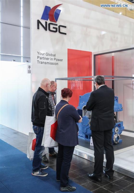 Visitors view an equipment displayed at the booth of Chinese wind power drive equipment manufacturer NGC at Hanover Fair 2019 in Hanover, Germany, April 2, 2019. Over 1,400 Chinese exhibitors attended the fair, the second most just after the host country Germany. Huawei, Haier and other Chinese manufacturers showed their most advanced networking and artificial intelligence technologies to the world. (Xinhua/Shan Yuqi)