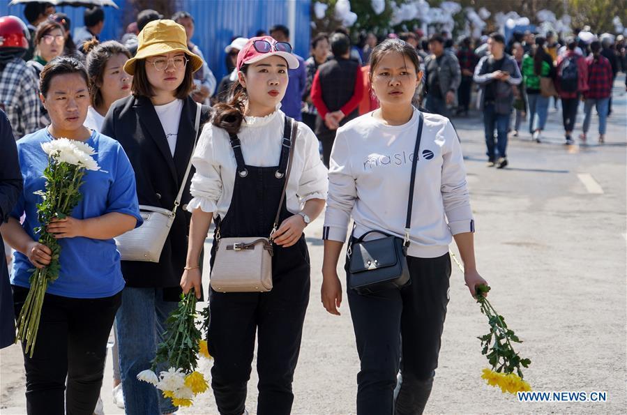 People present bouquets during a spontaneous mourning ceremony to pay tribute to those who lost their lives while fighting the forest fire in a funeral parlour in Xichang City, southwest China\'s Sichuan Province, April 2, 2019. A fire that killed 30 people and engulfed about 15 hectares of forest in southwest China\'s Sichuan Province was extinguished Tuesday, local authorities said. Thirty people, including 27 firefighters and three locals, lost their lives while fighting the fire. (Xinhua/Zhang Chaoqun)