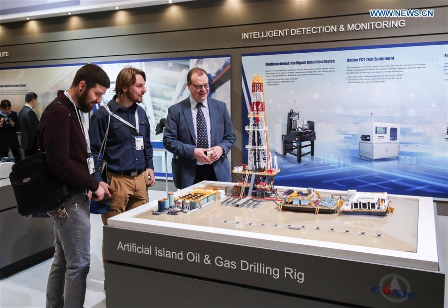 Visitors view a model of artificial island oil and gas drilling rig displayed at the booth of China Aerospace Science and Industry Corporation (CASIC) at Hanover Fair 2019 in Hanover, Germany, April 2, 2019. Over 1,400 Chinese exhibitors attended the fair, the second most just after the host country Germany. Huawei, Haier and other Chinese manufacturers showed their most advanced networking and artificial intelligence technologies to the world. (Xinhua/Shan Yuqi)