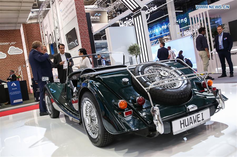 Visitors view a vehicle displayed at the booth of Chinese tech company Huawei at Hanover Fair 2019 in Hanover, Germany, April 1, 2019. Over 1,400 Chinese exhibitors attended the fair, the second most just after the host country Germany. Huawei, Haier and other Chinese manufacturers showed their most advanced networking and artificial intelligence technologies to the world. (Xinhua/Shan Yuqi)