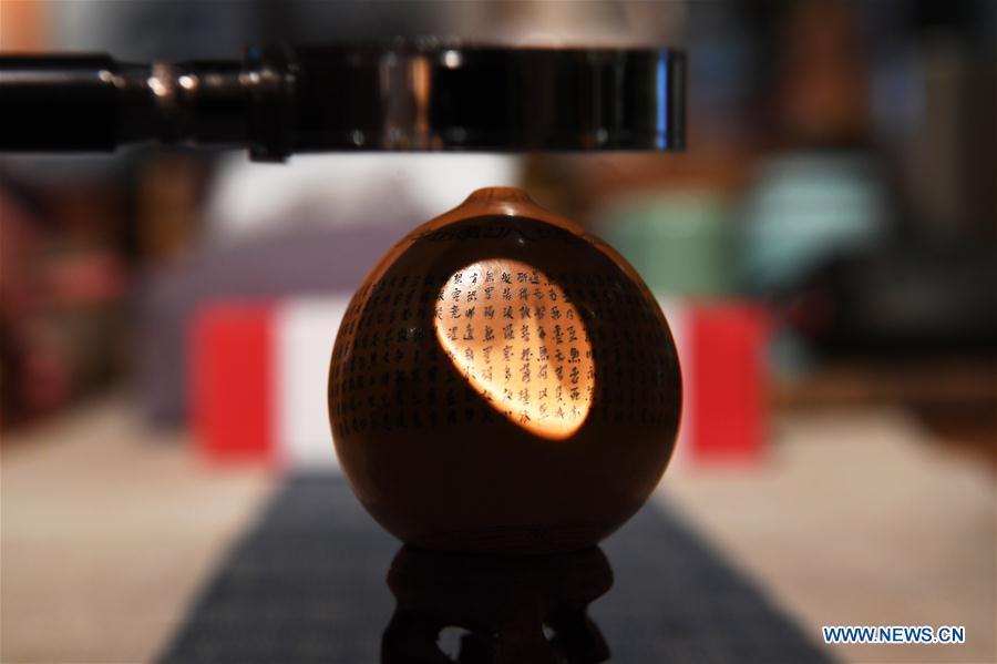 Photo taken on April 1, 2019 shows a part of a carved gourd named \