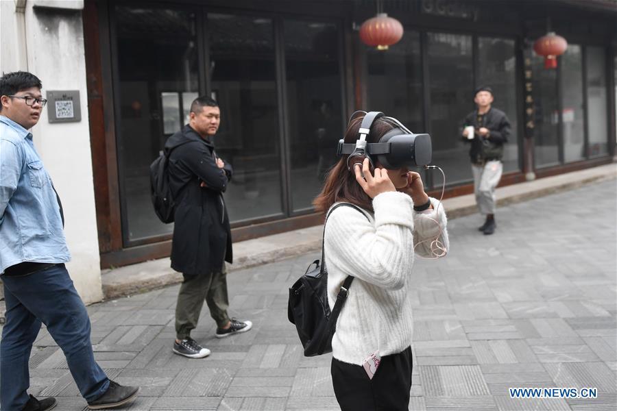 A woman tries on a VR headset that simulates the life of people with Autism Spectrum Disorder (ASD) in Hangzhou, east China\'s Zhejiang Province, April 2, 2019, the World Autism Awareness Day. World Autism Awareness Day on April 2 every year is designated to encourage member states of the United Nations to take measures to raise awareness about people with ASD throughout the world. (Xinhua/Huang Zongzhi)
