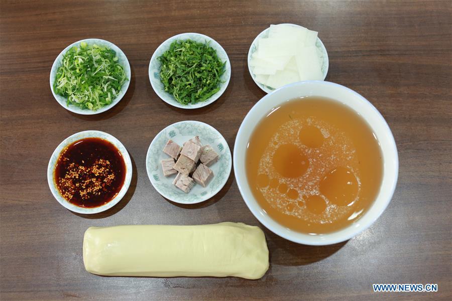 Photo taken on April 2, 2019 shows materials and seasoners for making Lanzhou beef noodles at a noodle restaurant in Lanzhou, capital of northwest China\'s Gansu Province. Lanzhou beef noodles, a Chinese hand-pulled noodle originated in Lanzhou, has a history of about 100 years. There are about ten types of noodles of different width and shapes, depending on noodle chefs\' pulling skills. It has won fame both at home and abroad with its speciality of noodles and soup recipe. (Xinhua/Ma Ping)