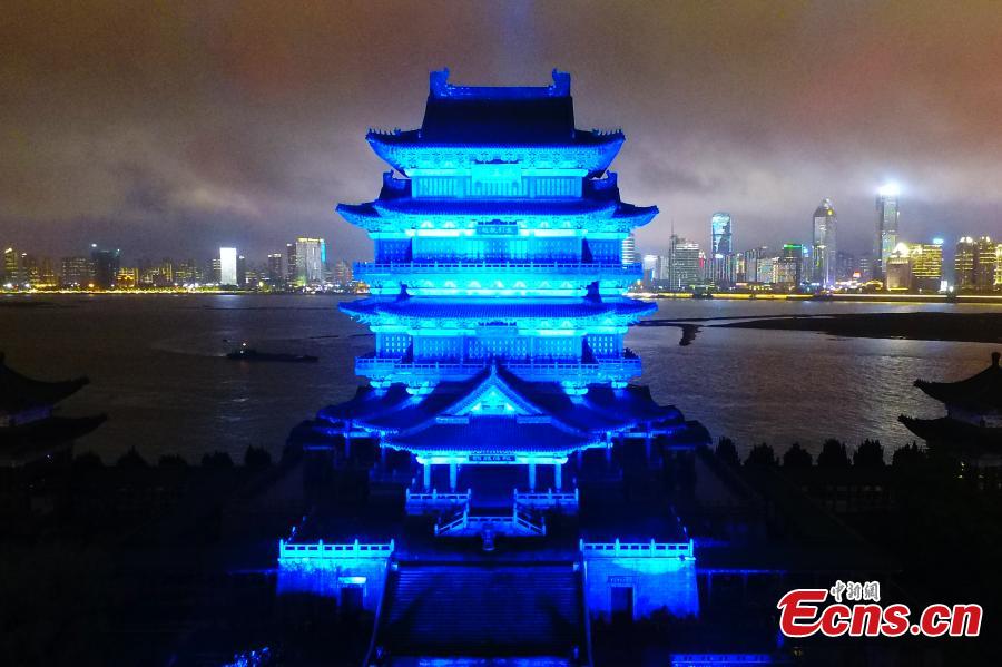 The historical Pavilion of Prince Teng is illuminated by blue lights during an event to mark World Autism Awareness Day, in Nanchang City, Jiangxi Province, April 2, 2019. The pavilion is on the east bank of the Ganjiang River and is one of the Three Great Towers of southern China. A total of 16 historical and cultural buildings in China took part in the light-up event to mark the day, which aims to raise awareness with Autism Spectrum Disorder throughout the world. (Photo: China News Service/Liu Zhankun)
