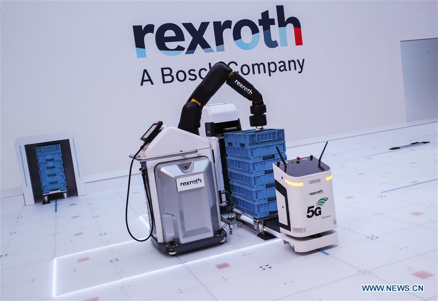 Robots utilizing 5G network are displayed at the booth of German-based drive and control company Bosch Rexroth during the 2019 Hanover Fair in Hanover, Germany, April 2, 2019. (Xinhua/Shan Yuqi)
