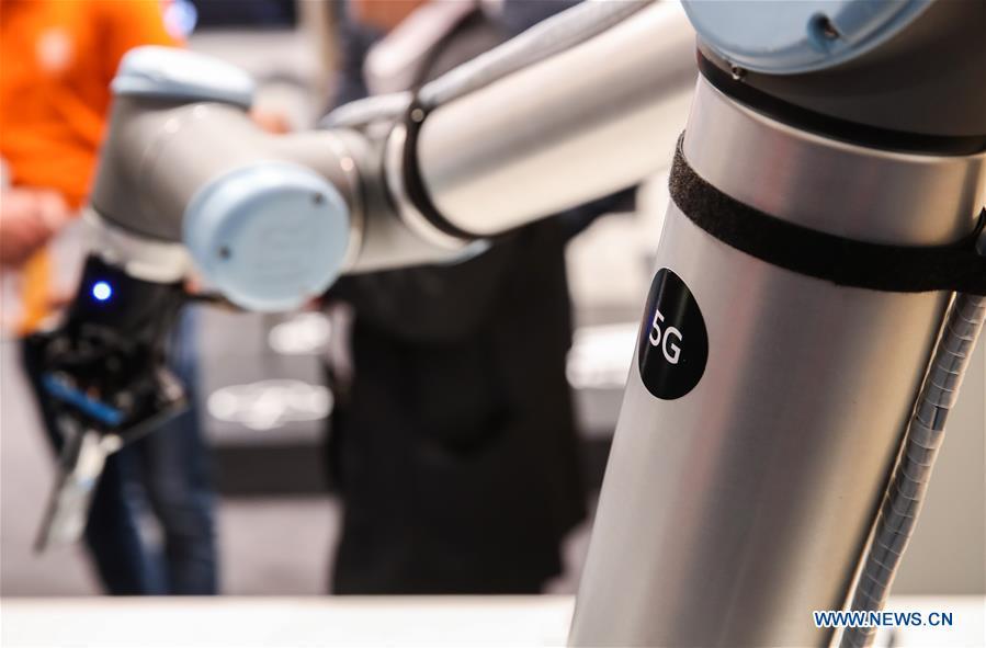 A robotic arm utilizing 5G network is displayed at the booth of Ericsson during the 2019 Hanover Fair in Hanover, Germany, April 2, 2019. (Xinhua/Shan Yuqi)