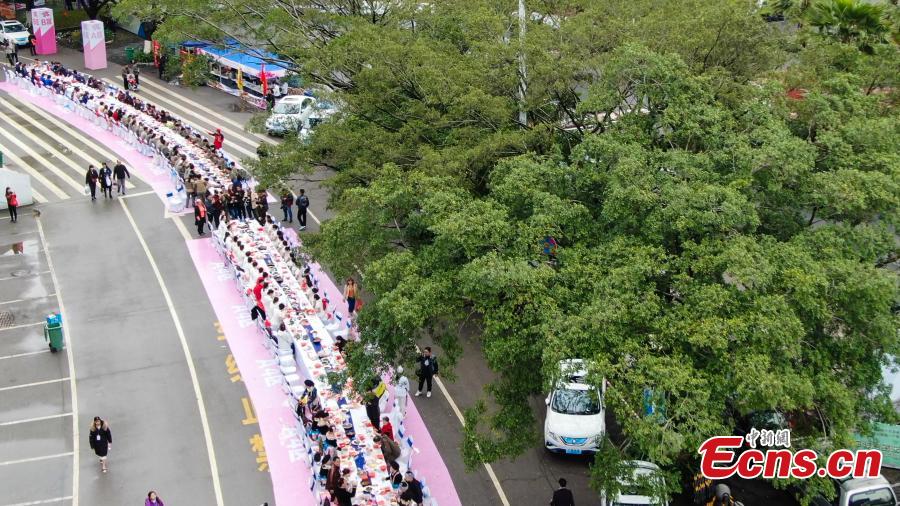 Aerial photo taken on April 3, 2019 shows people eat Luosifen, a local rice noodle dish featuring cooked river snails as ingredient, at a long-table feast in Liuzhou, south China\'s Guangxi Zhuang Autonomous Region. More than 2,000 people joined the feast which was served on tables measuring 1,000 meters in length here on Wednesday.  (Photo/China News Service)