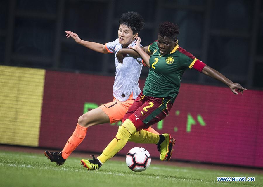 Wang Shanshan (L) of China vies with Christine Manie of Cameroon during the final match between China and Cameroon at the 2019 International Women\'s Football Tournament in Wuhan, central China\'s Hubei Province, April 7, 2019. (Xinhua/Xiao Yijiu)
