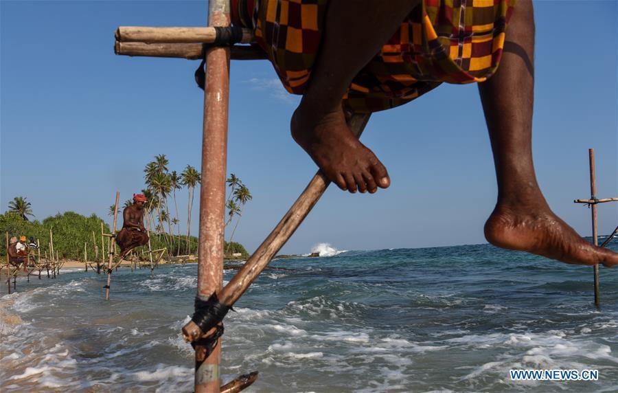Stilt fishermen are seen at a beach in Galle, Sri Lanka, April 7, 2019. Stilt fishing is a method of fishing unique to the island country of Sri Lanka. Local fishermen sit on a crossbar called \