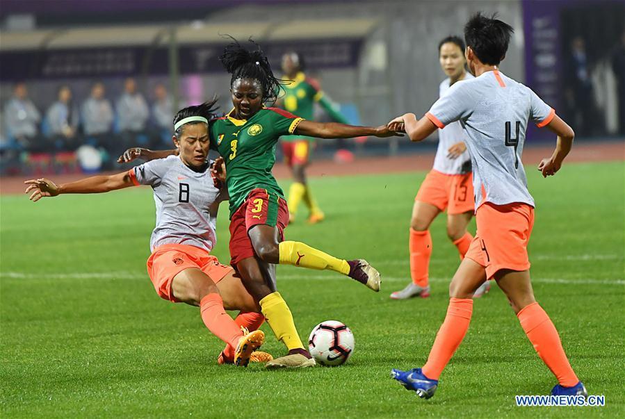 Ajara Nchout Njoya (2nd L) vies with Li Jiayue (1st L) of China during the final match between China and Cameroon at the 2019 International Women\'s Football Tournament in Wuhan, central China\'s Hubei Province, April 7, 2019. China won 1-0. (Xinhua/Xiong Qi)