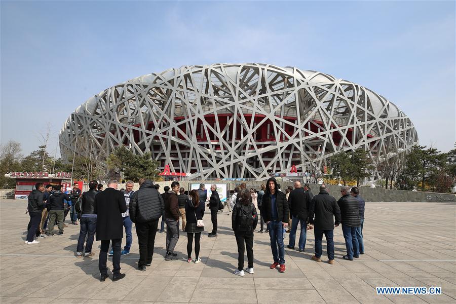 Photo taken on April 8, 2019 shows representatives from major world news agencies on the Olympic Green in front of the National Stadium during a venue visit prior to the First World Agency Meeting of Beijing 2022, in Beijing, capital of China. Representatives from major world news agencies are visiting Beijing for a first look at some of the facilities to be used at the 2022 Winter Olympic Games. (Xinhua/Xu Zijian)