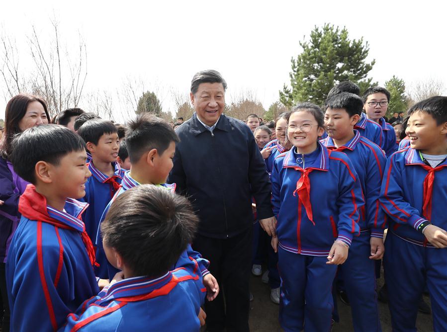 Chinese President Xi Jinping, also general secretary of the Communist Party of China Central Committee and chairman of the Central Military Commission, talks with school children as he attends a tree-planting activity in Tongzhou District in Beijing, capital of China, April 8, 2019. Other Party and state leaders, including Li Zhanshu, Wang Yang, Wang Huning, Zhao Leji, Han Zheng and Wang Qishan, also attended the activity. (Xinhua/Ju Peng)
